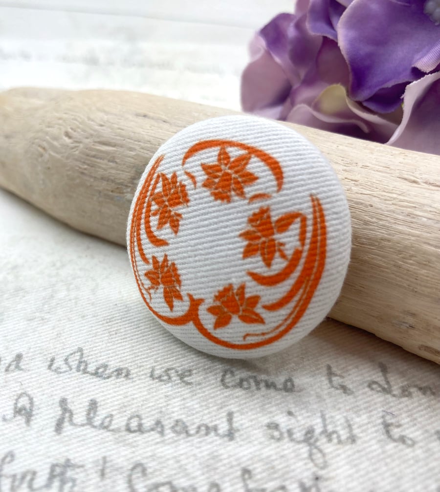Orange Art Nouveau stylised daffodil fabric button brooch