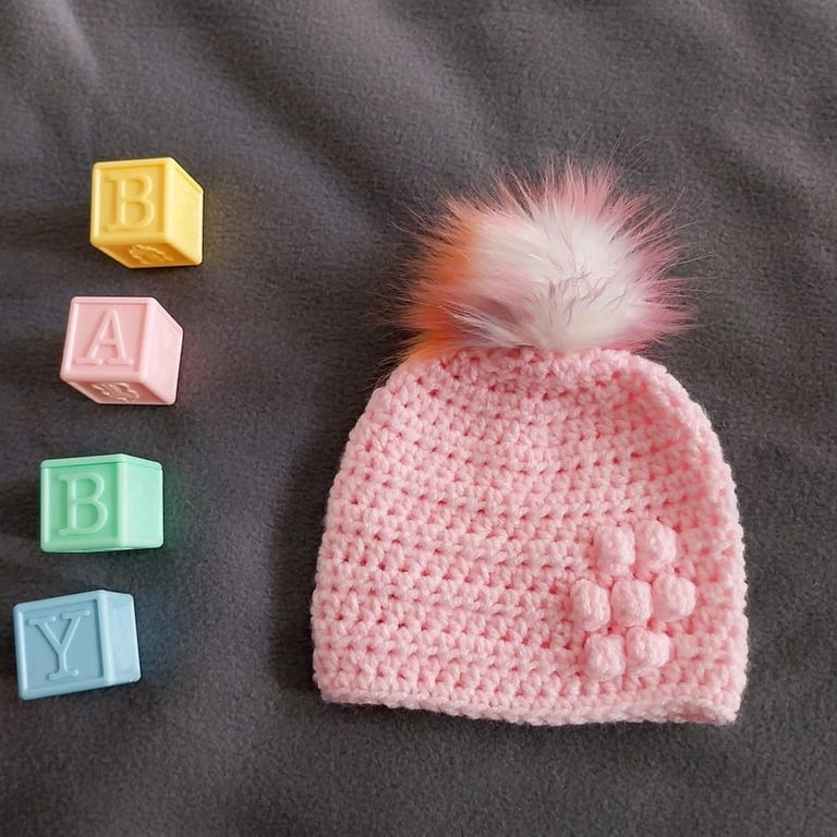 Pink baby crocheted hat white faux fur pompom with orange purple & pink 