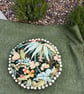 Round feature cushion in vintage leafy linen with pompoms - Image 9