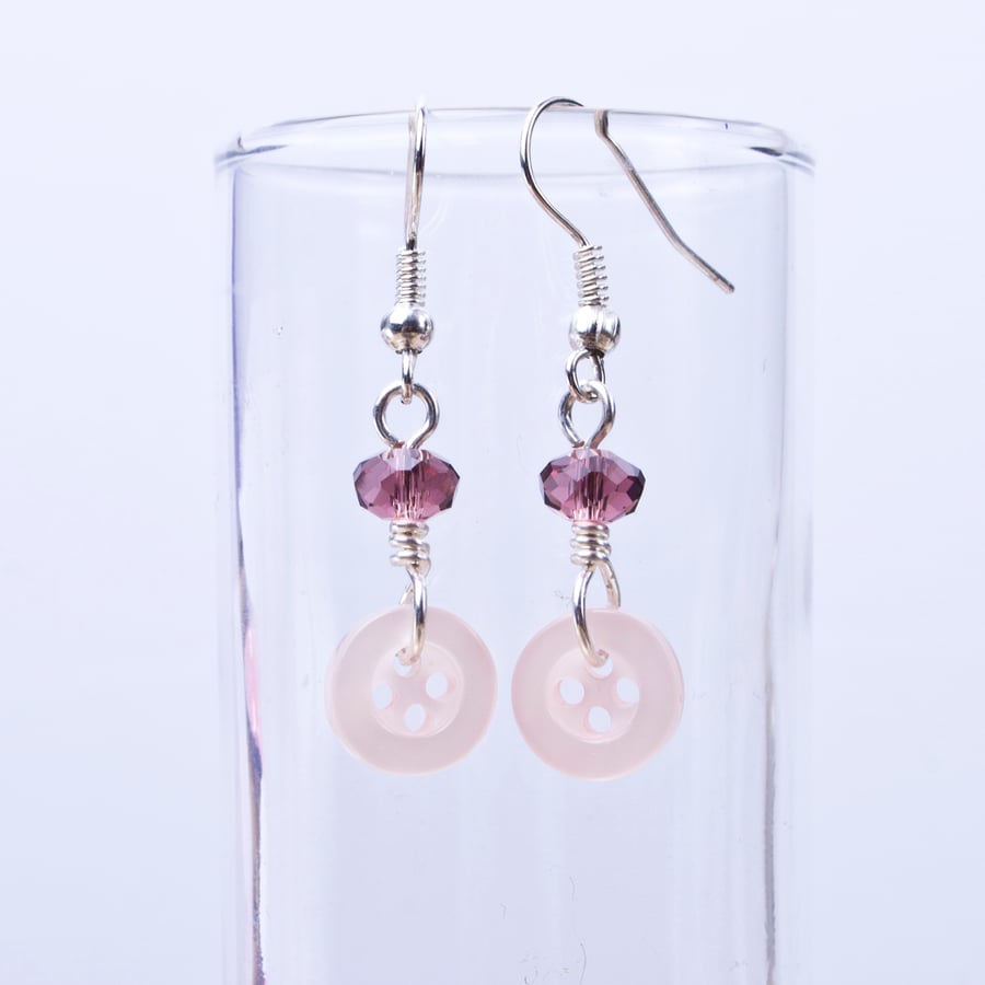 Pink button earrings with purple faceted beads