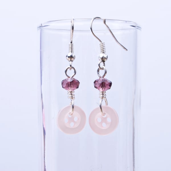 Pink button earrings with purple faceted beads