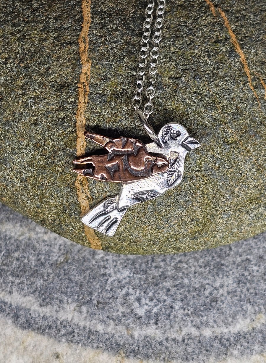 Little Bird, a hallmarked sterling silver and copper pendant. 