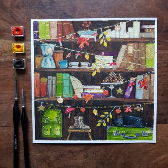 Bookshelves with autumnal decorations, walking boots, black cat original art 