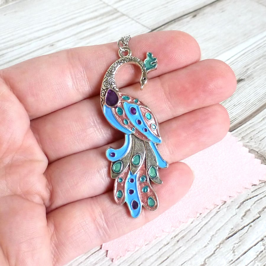 Image of Sky blue peacock pendant with rose gold, turquoise and purple accents