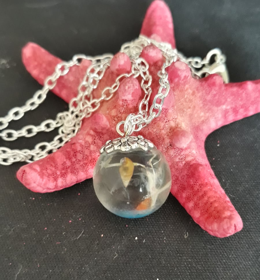 R8. Seaside themed resin globe necklace