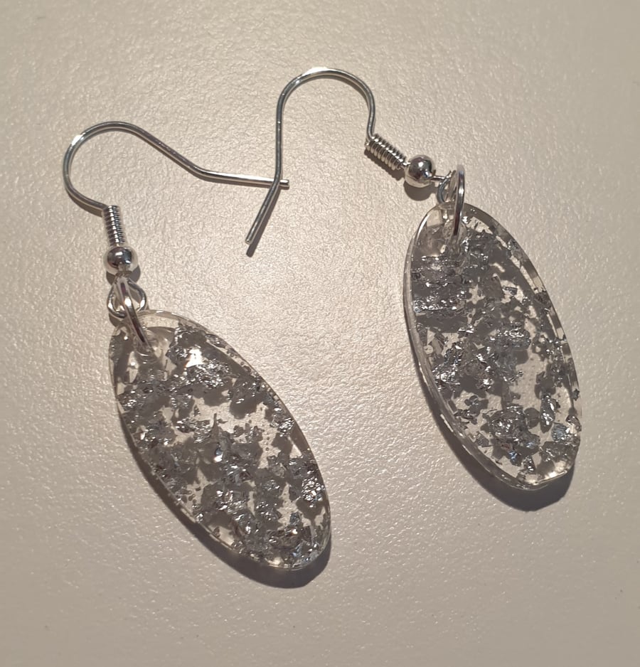 Oval silver metallic flakes resin earrings