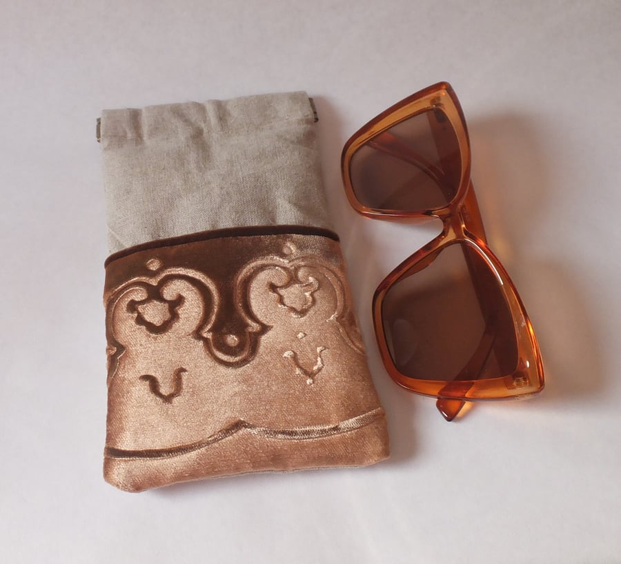 Gold glasses case with embossed velvet border and linen design, flex snap top.