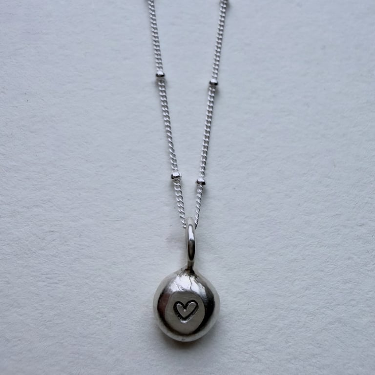 Handmade silver pebble pendant with heart