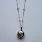 Handmade silver pebble pendant with heart