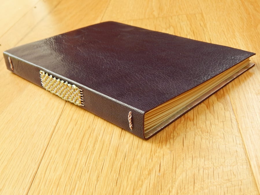 Aubergine Leather Journal with lined pages, gold & silver woven stitching. 