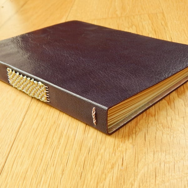 Aubergine Leather Journal with lined pages, gold & silver woven stitching. 