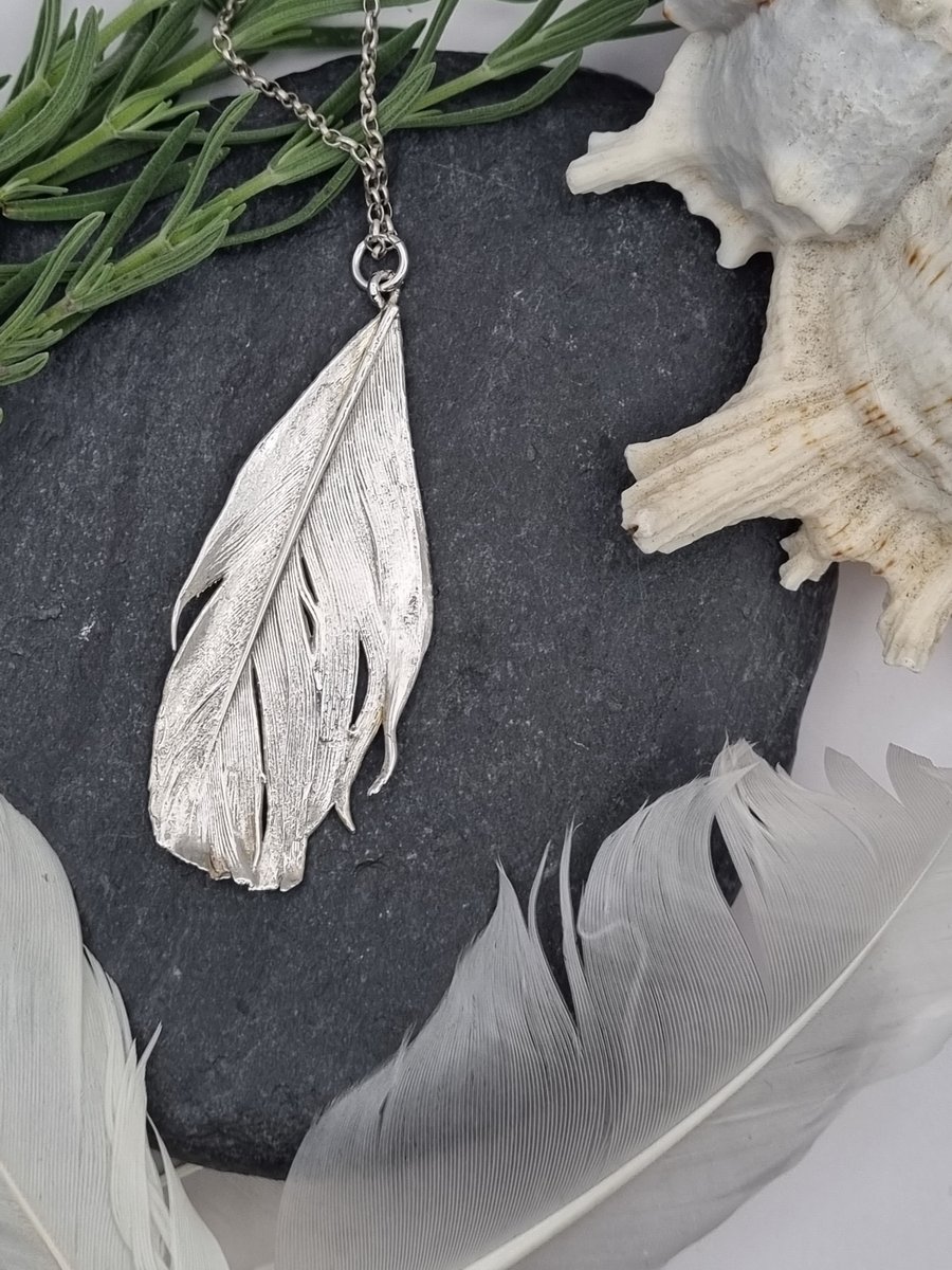Real feather preserved in silver pendant necklace