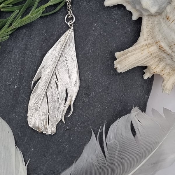Real feather preserved in silver pendant necklace
