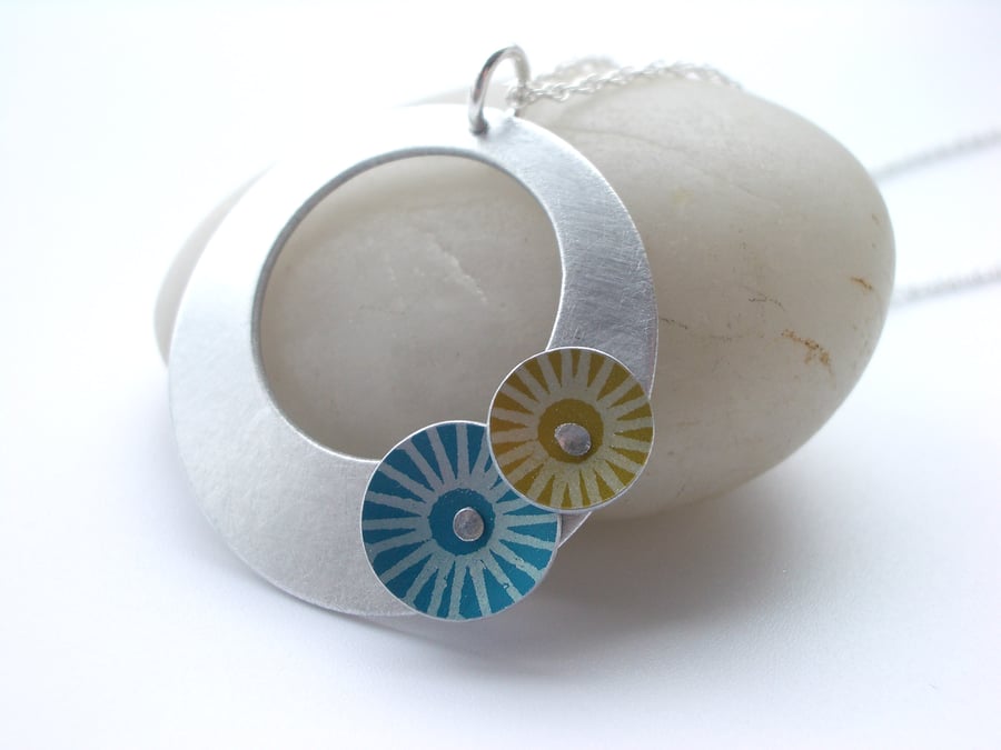 Circle pendant necklace in brushed aluminium with blue and yellow discs