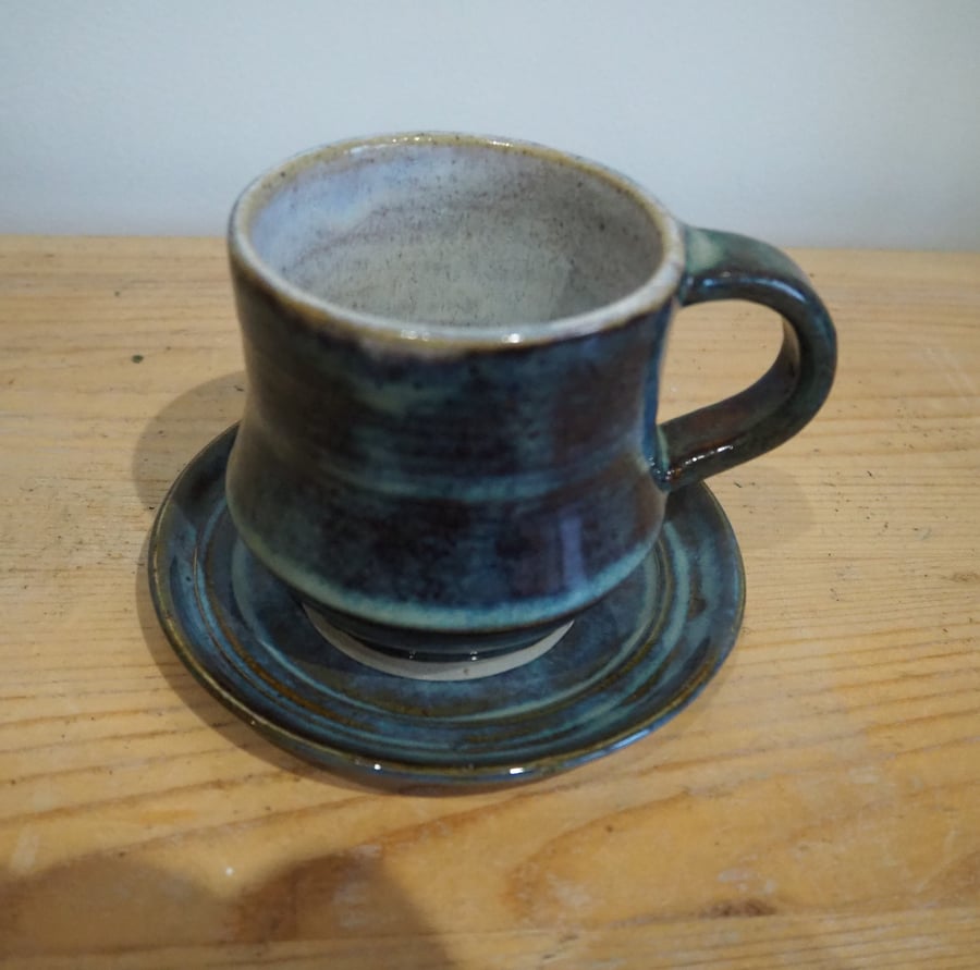 Pottery mug and saucer blue and white glazes. Angluar shape. Handmade.