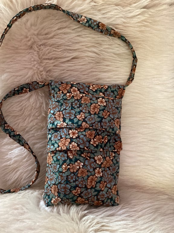 Floral needlecord crossbody bag.