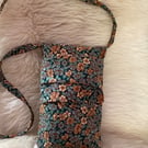 Floral needlecord crossbody bag.
