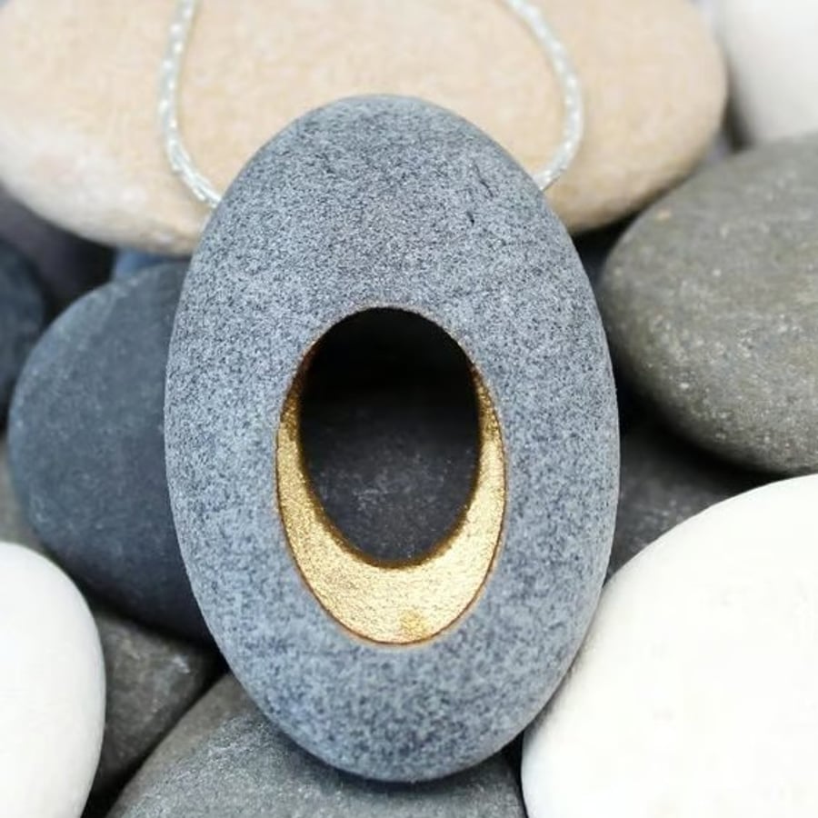 Pebble pendant necklace, nature inspired with a golden hollow centre.