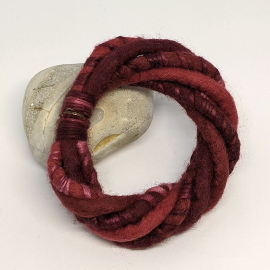 Felted cord bracelet in shades of red