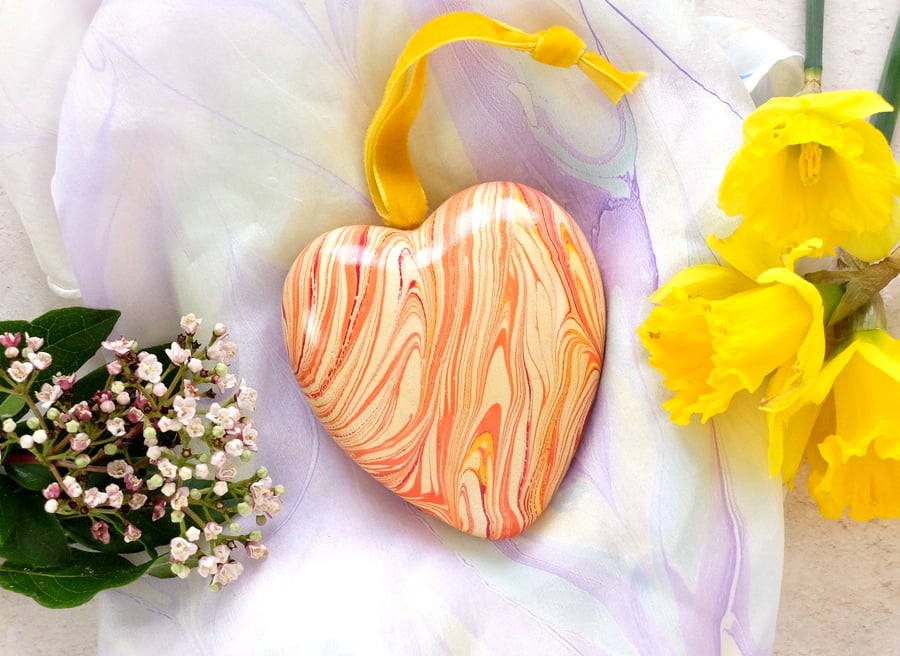 Hanging marbled ceramic heart decoration in hot colours slight second