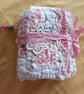 The pink and white needlecase, with pockets, pins, needles and  samples