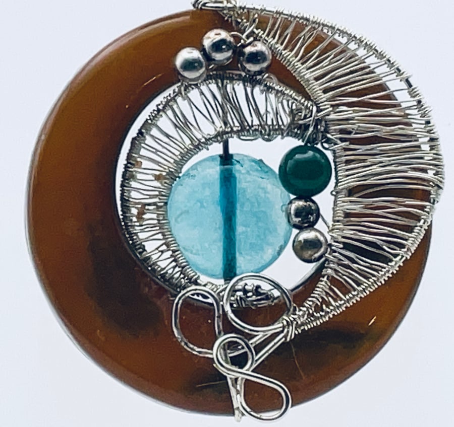 Burnt orange carnelian circlet with aqua colour disk and silver wired pendant