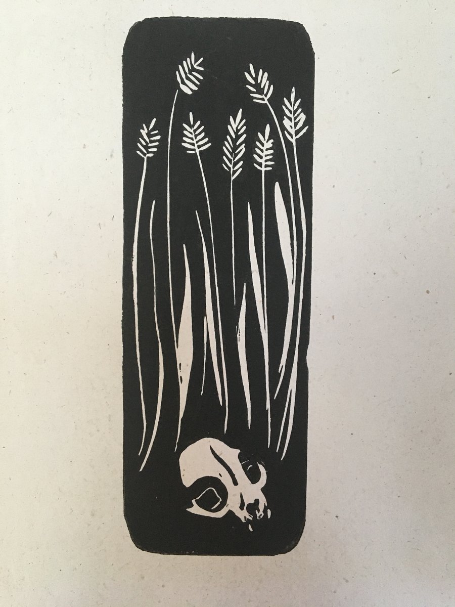 Ceres, linocut print of a cat skull in wheat field. 