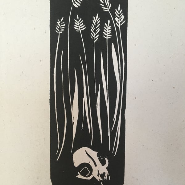 Ceres, linocut print of a cat skull in wheat field. 