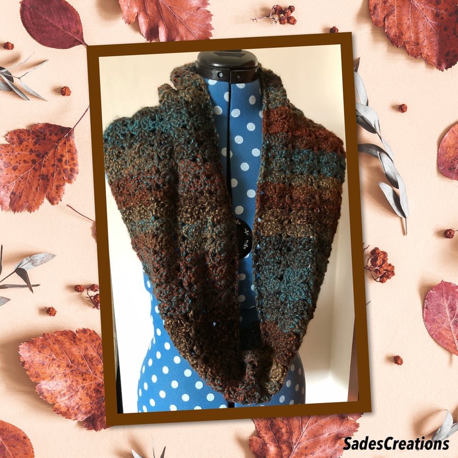 Stylish warm snood made with marble chunky yarn in the shade of rust blue.