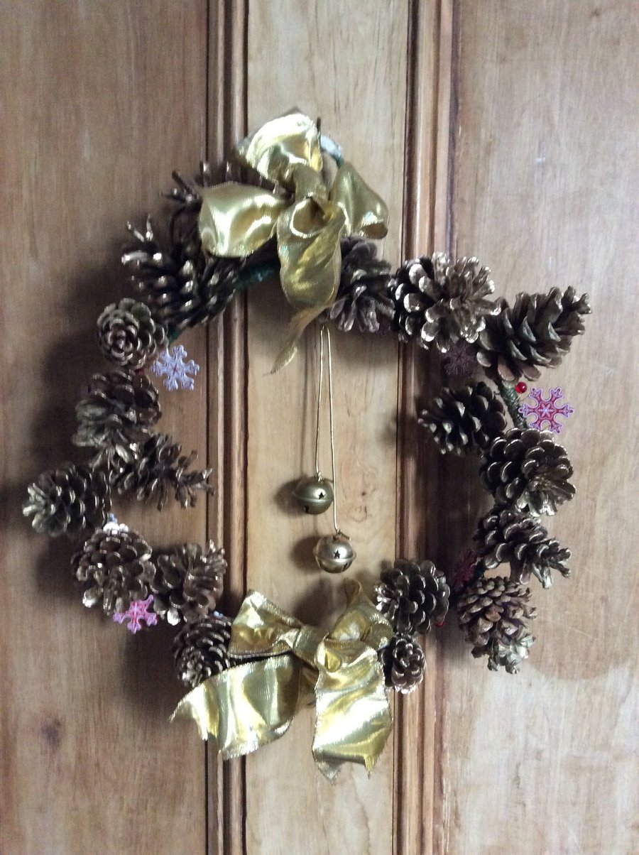 Gold wreath with fir cones and bells