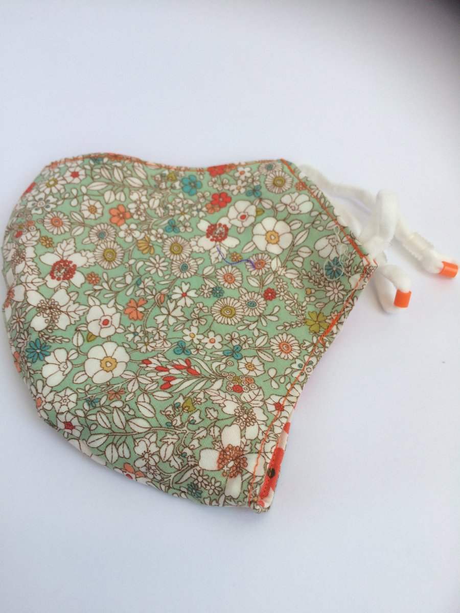Medium reusable double layered, washable and adjustable floral face mask
