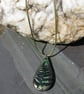 Metallic green and bronze fern tear-drop pendant on a green woven cord. - Image 2