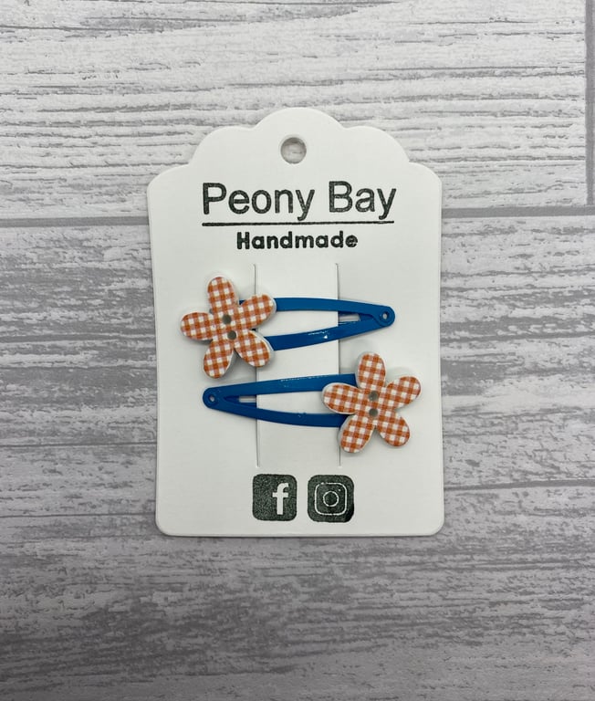 Girl’s flower hair clips in orange and blue 