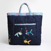 Navy blue bag with front pocket and four hand stitched fish