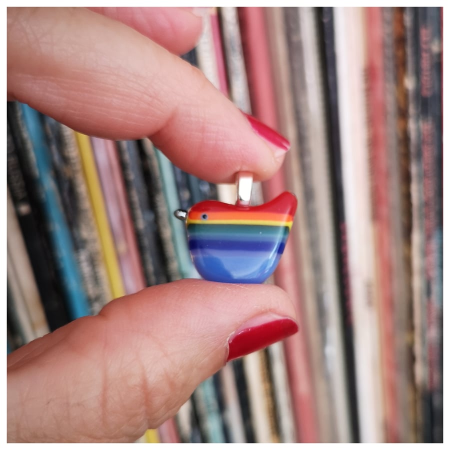 little 'Rainbow Wren of Hope' glass pendant with a red back