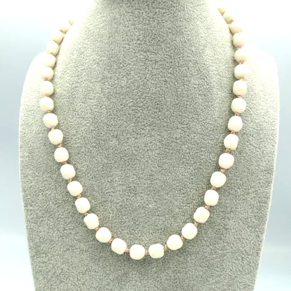 Cream glass pearl necklace  Traditionally knotted with pink silk thread 