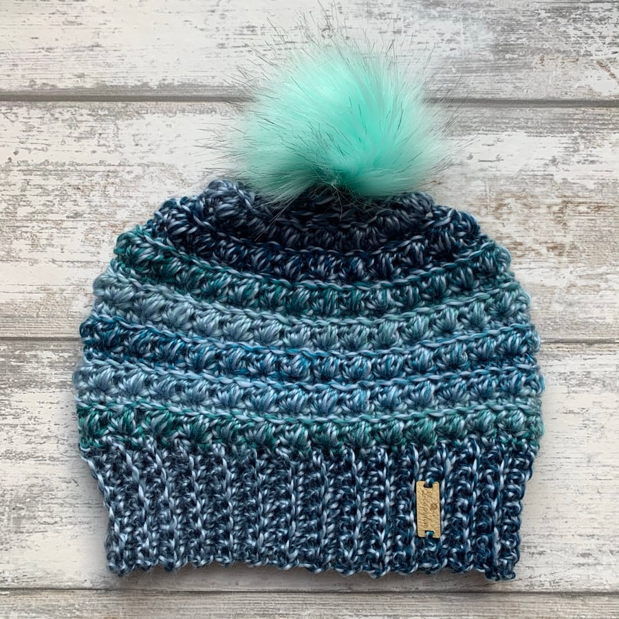 Handmade green and blue crochet beanie hat with colourful green faux fur pompom