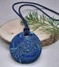 Round polymer clay pendant in a mixture of blues