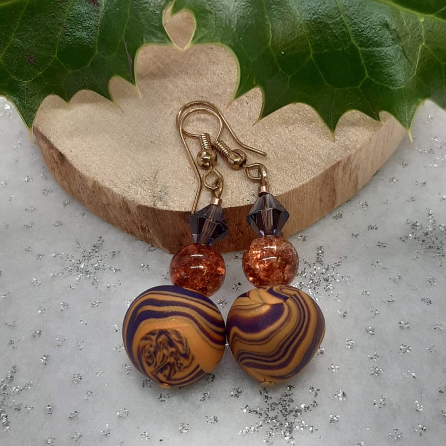 Dangly earrings in purple and gold polymer clay swirl