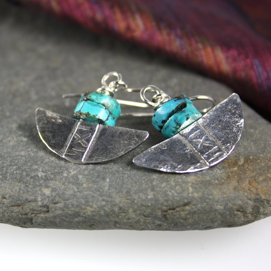 Silver and turquoise tribal blade earrings.