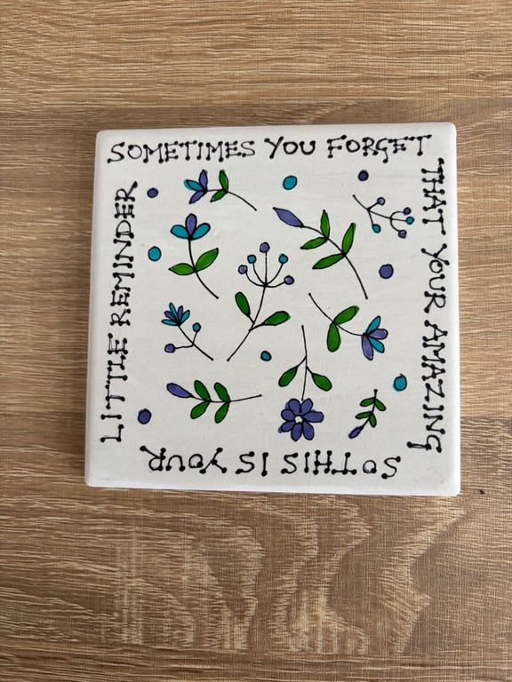 Ceramic coaster with hand drawn design and quote