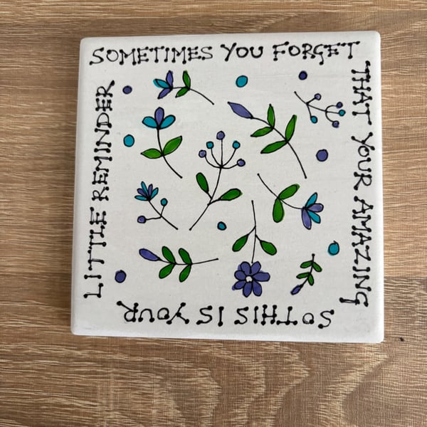 Ceramic coaster with hand drawn design and quote