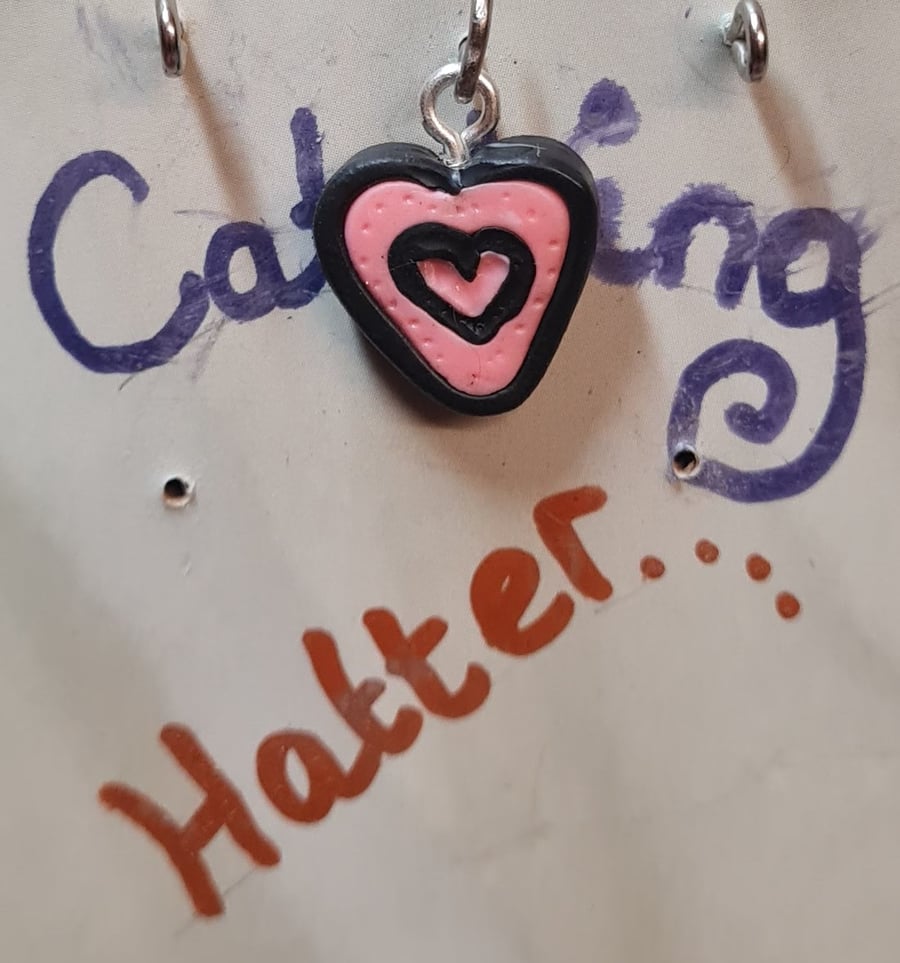 Pink and black heart pendant.