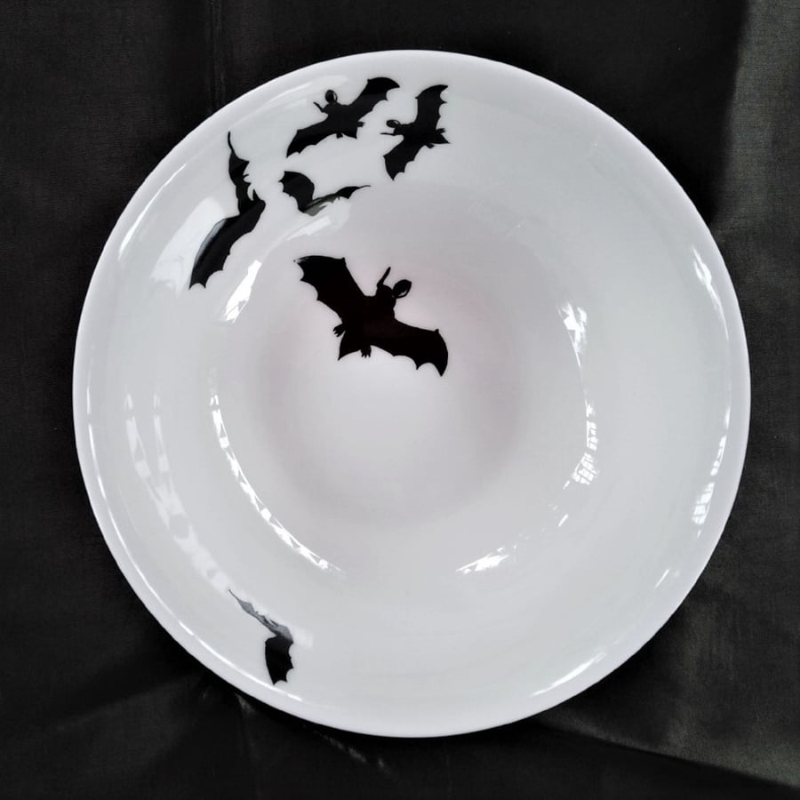 A flock or cauldron of flying bats on a bone china pudding or dessert bowl.