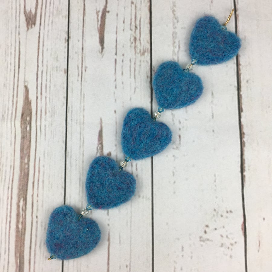 Hanging heart garland, needle felted and beaded, in blue