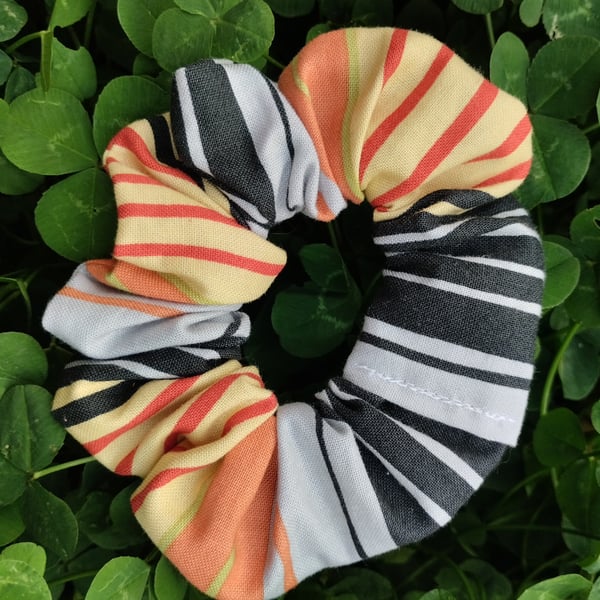 Striped grey red orange yellow black scrunchie