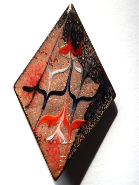 brooch: diamond shape - scrolled red and black over clear enamel
