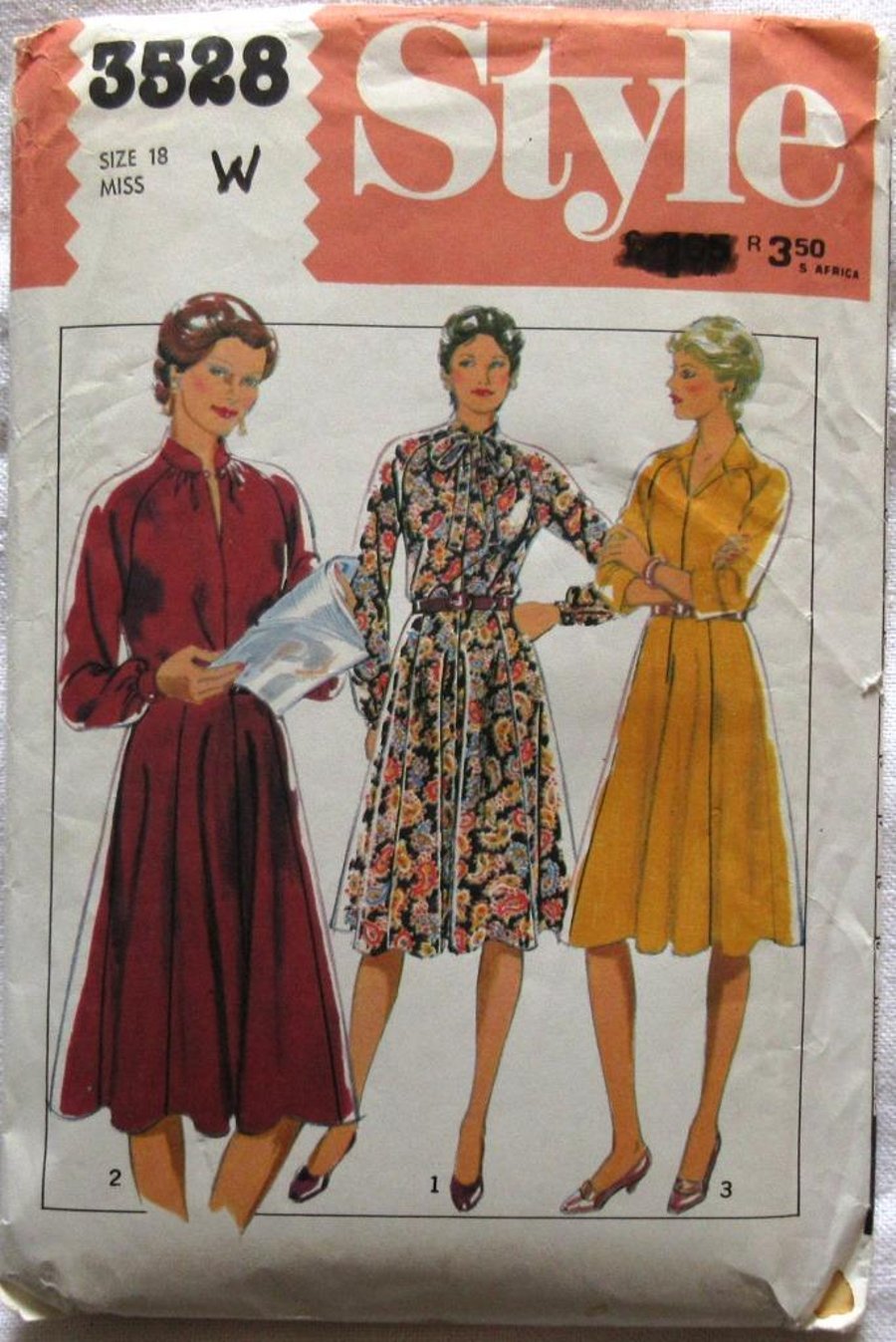 An uncut vintage sewing pattern for a misses' long-sleeved dress in size 18