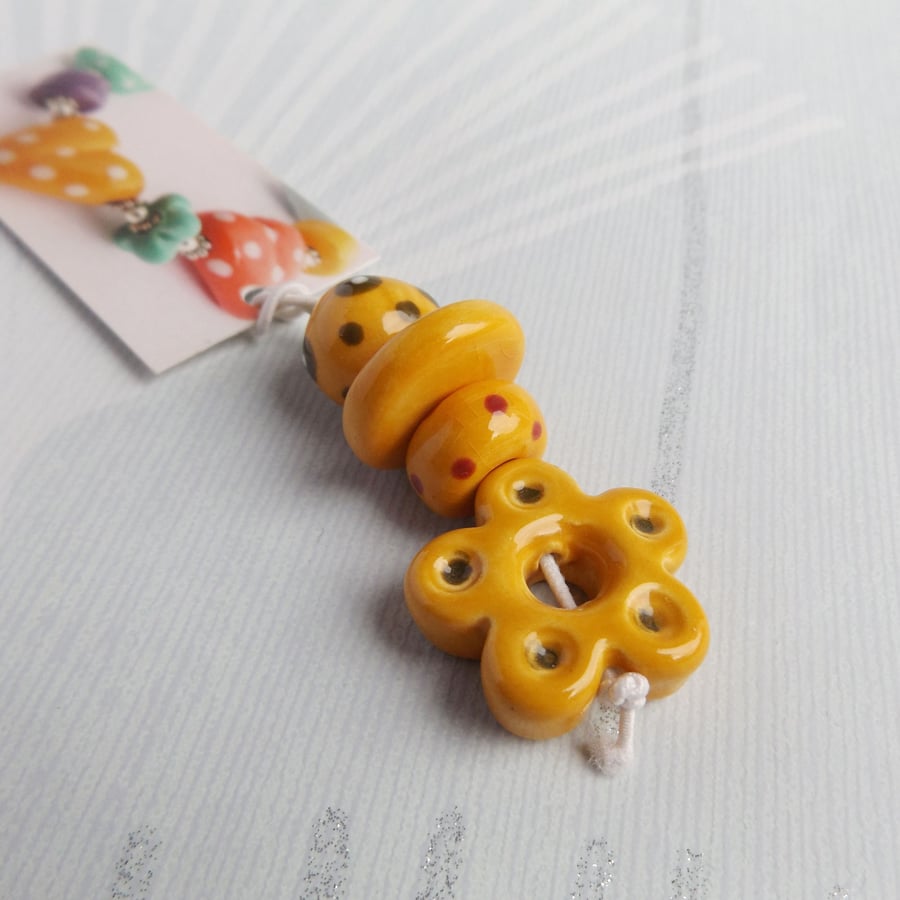 Handmade Ceramic Bead Set with Flower Pendant in warm yellow tones