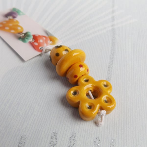 Handmade Ceramic Bead Set with Flower Pendant in warm yellow tones